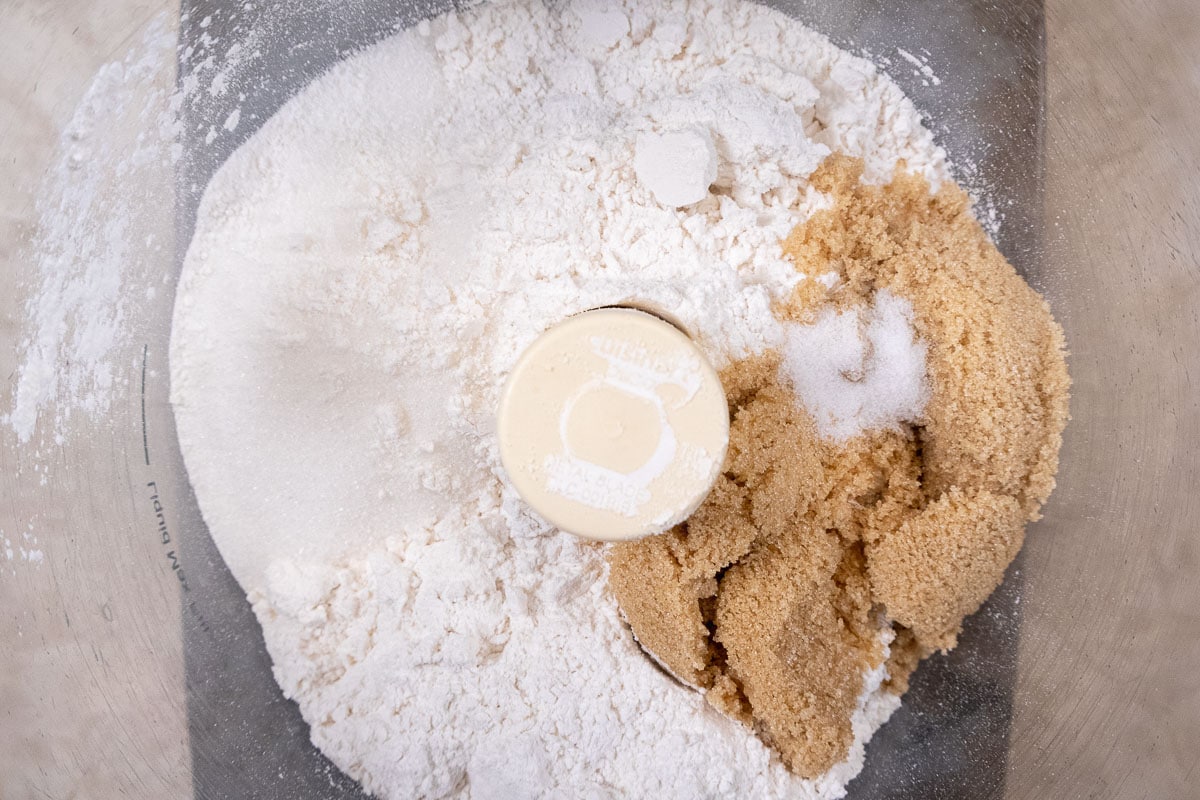 The dry ingredients are placed in the bowl of a processor.