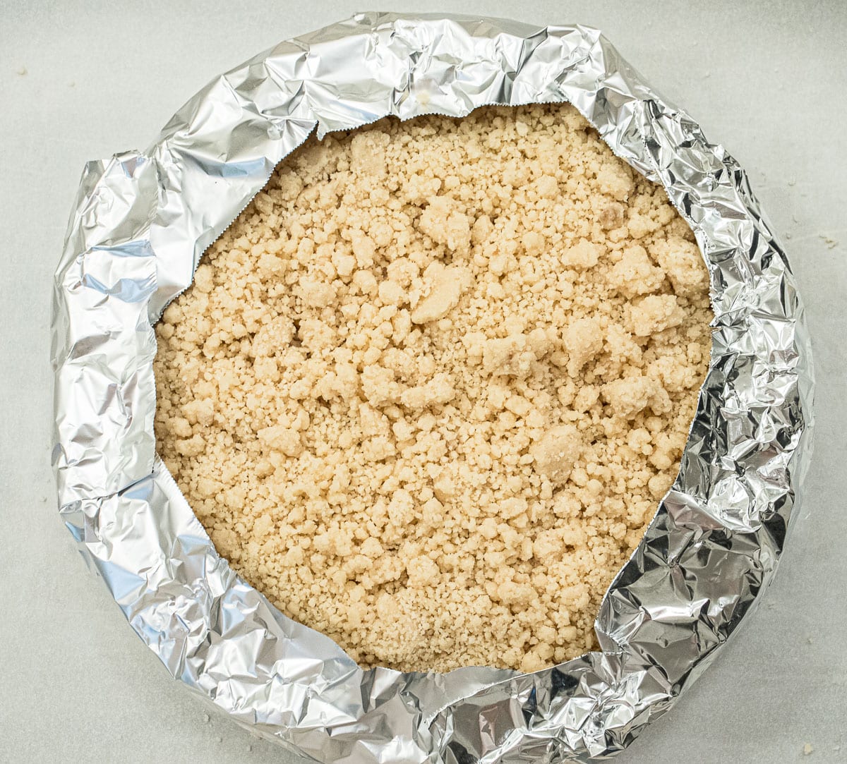 The edges of the pie are covered with foil to prevent overbrowning.