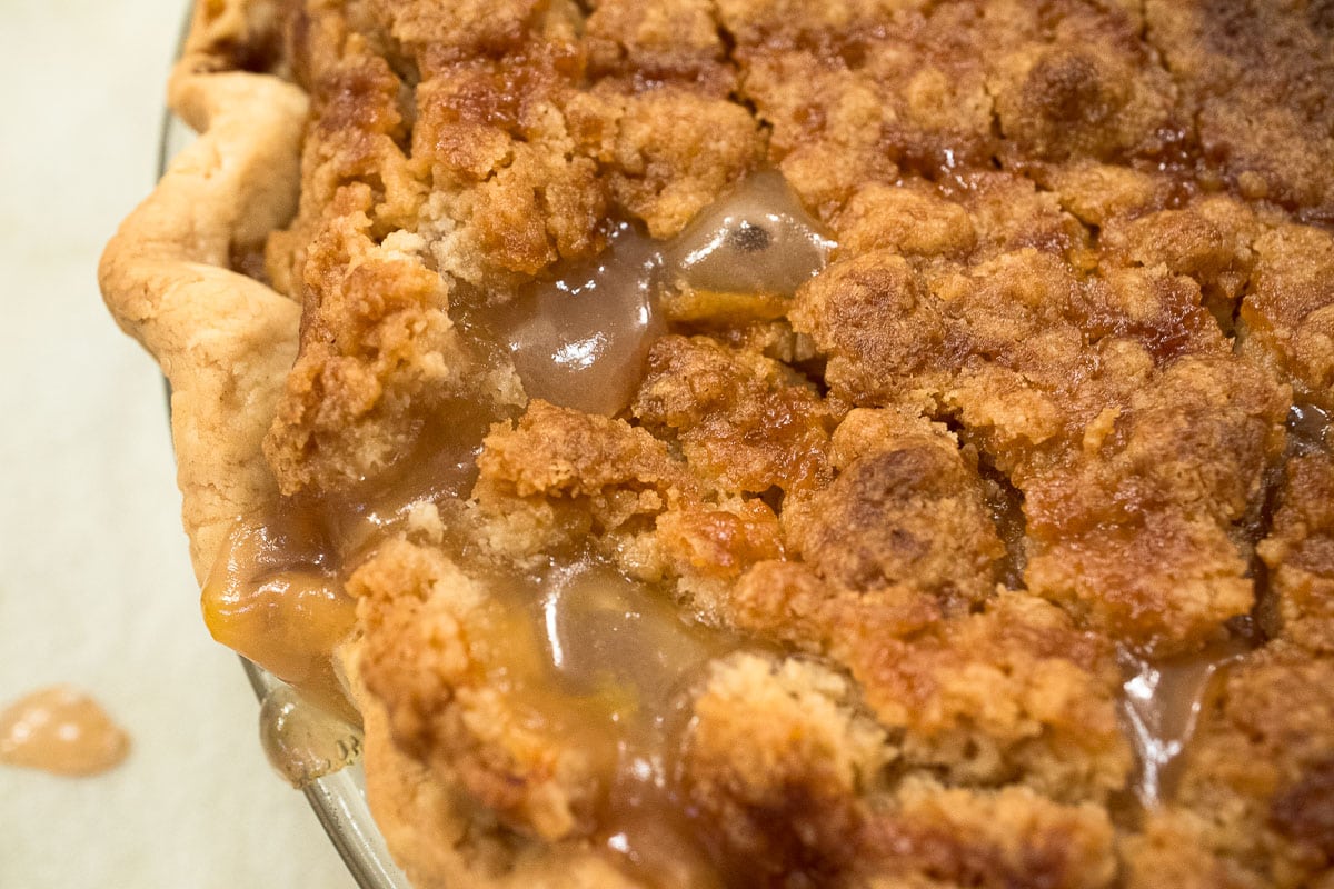 The pie is baked until the filling bubbles up through the crumbs.