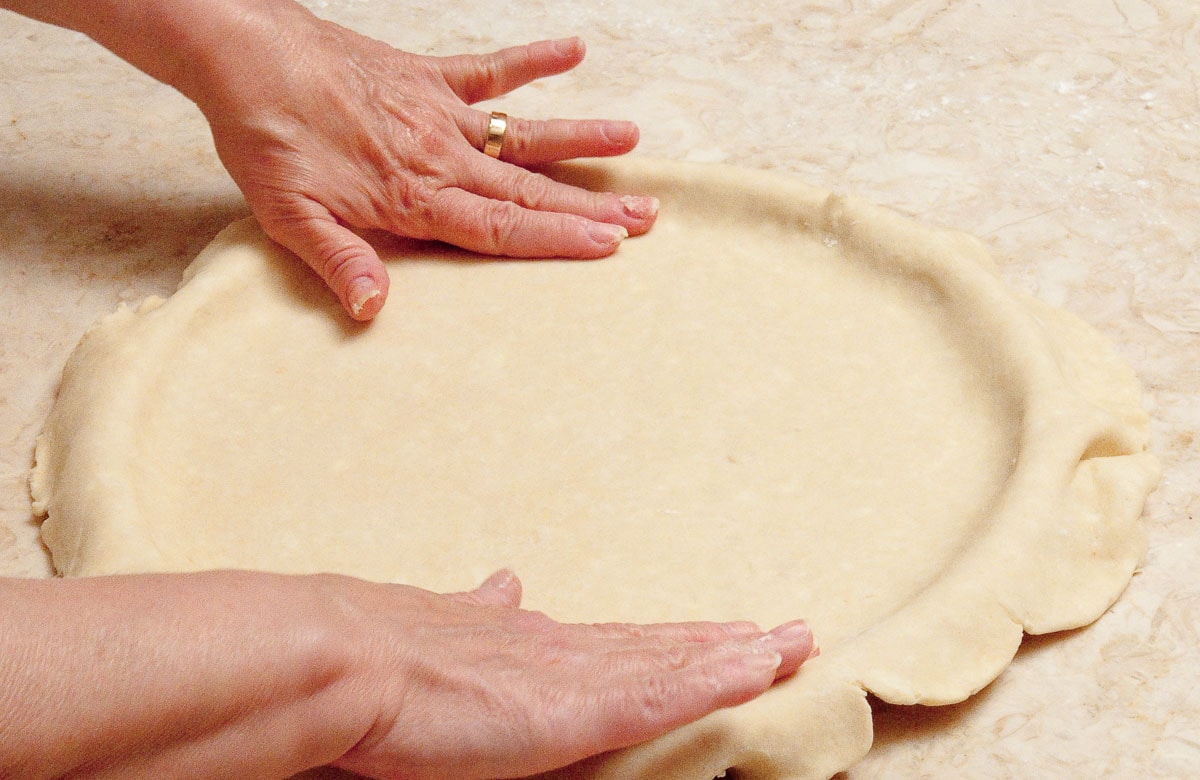The pastry has been rolled to a 14"circle and placed in the pan.