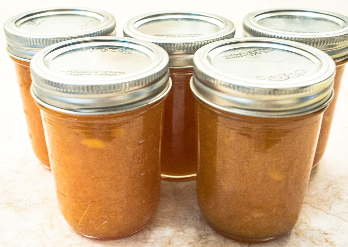The jam is immediately poured into jars and the lids are put on.