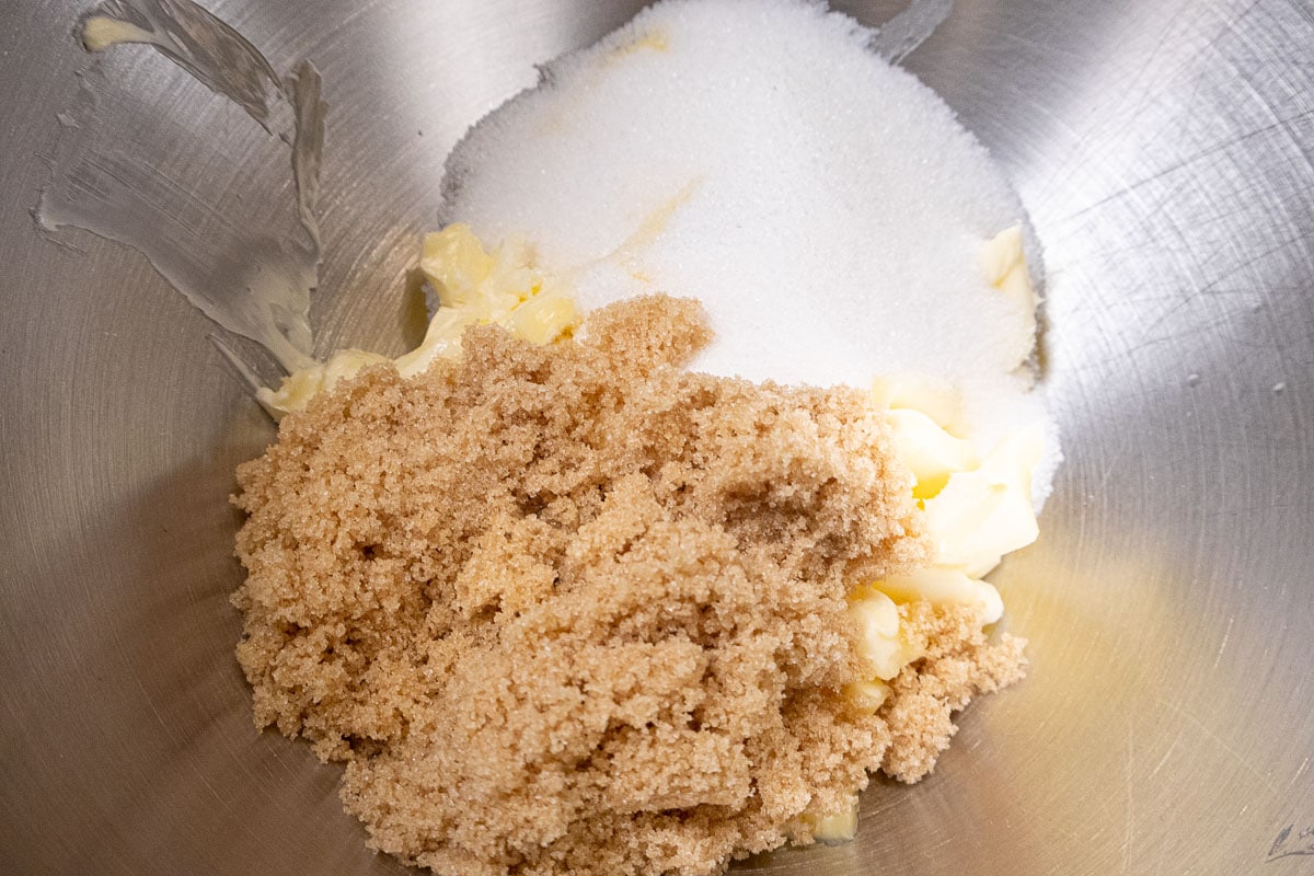 The butter, granulated sugar and brown sugar are placed in a mixing bowl.