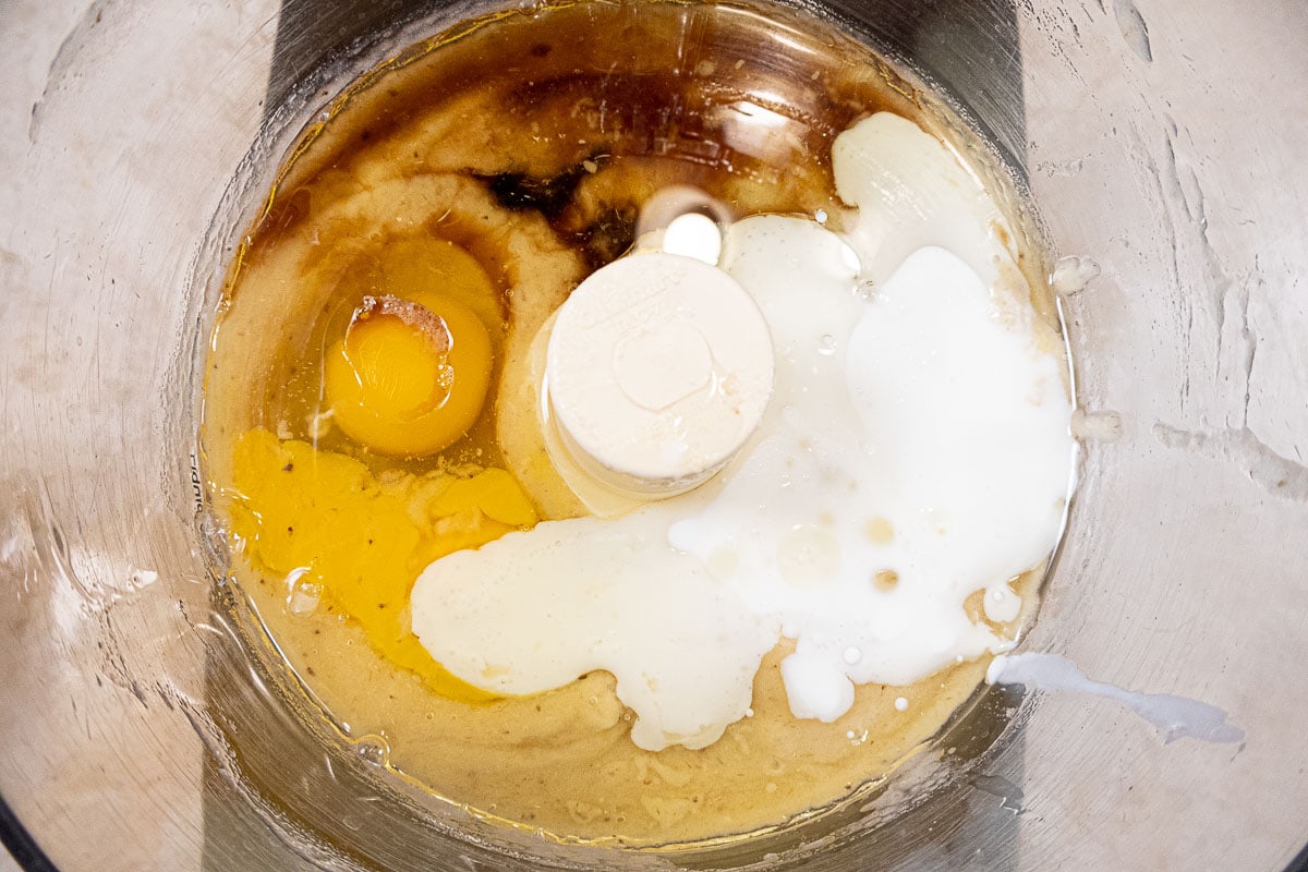 The eggs, buttermilk, oil and vanilla are added to the processor bowl.