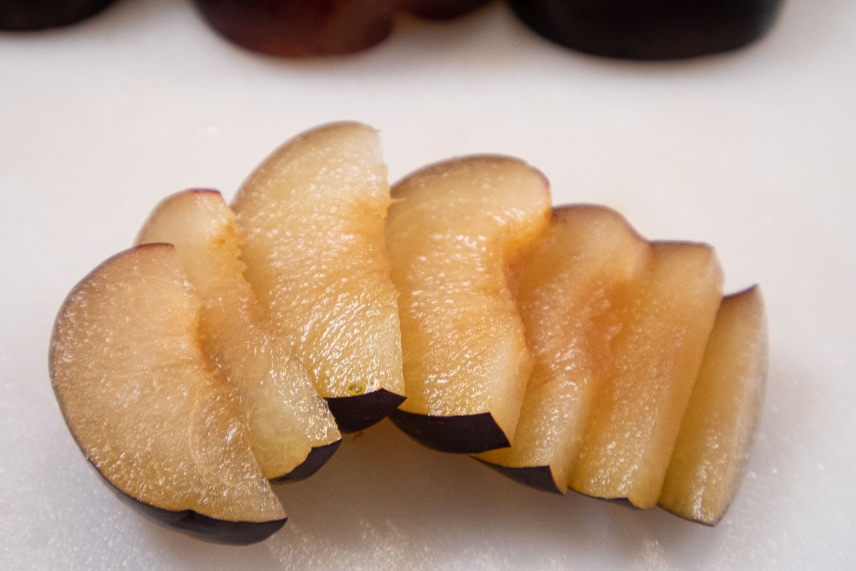 The plums are cut into ¼" slices.