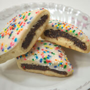 A plate of Cuccidati, fig and nut filled Italian Cookies sprinkled with multi-colored nonpariels.