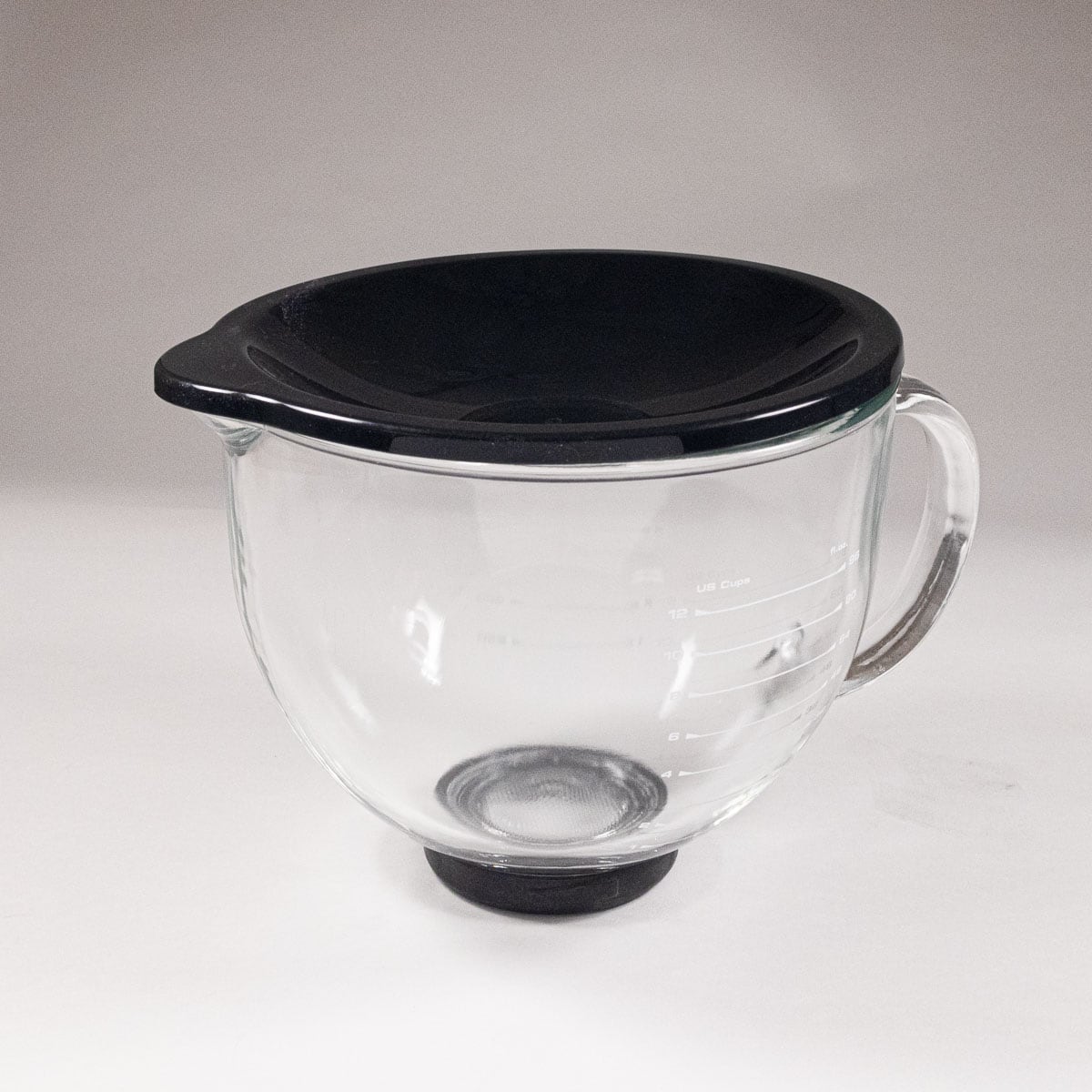 Glass bowl with a black plastic cover on top.