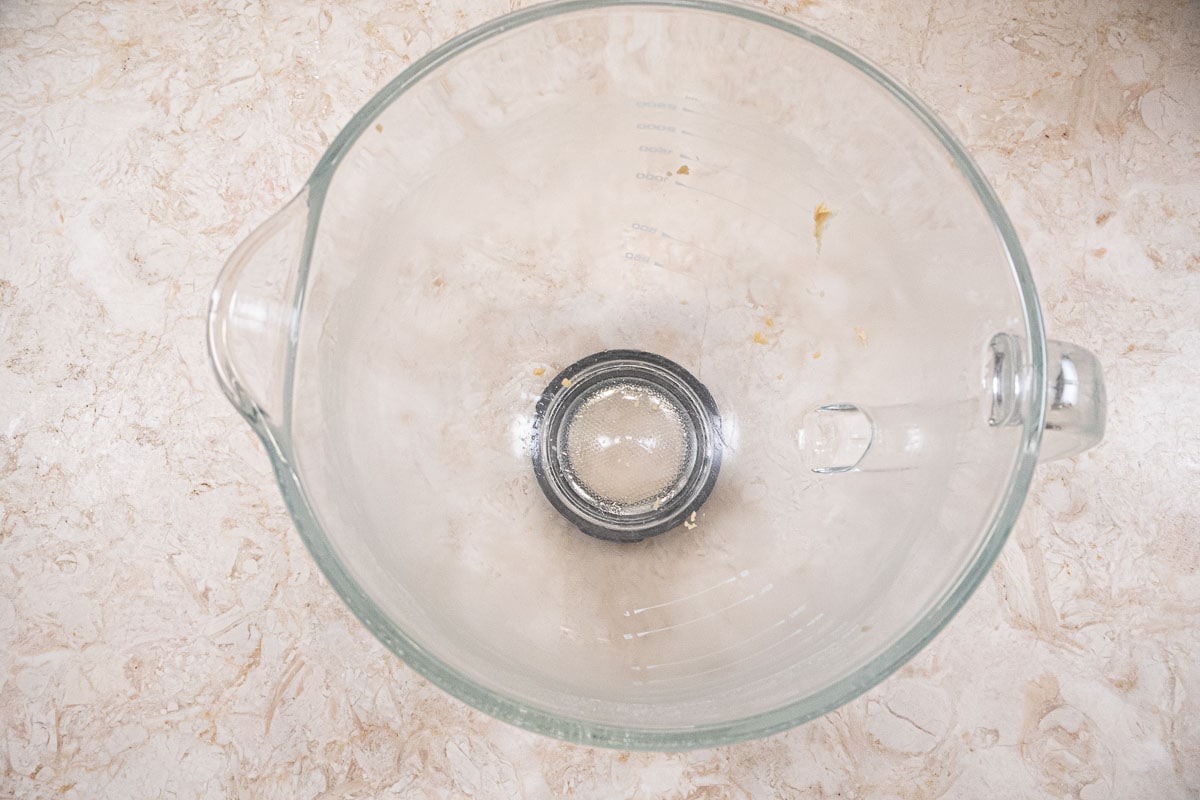 Bread dough removed from the glass bowl leaving it almost clean.