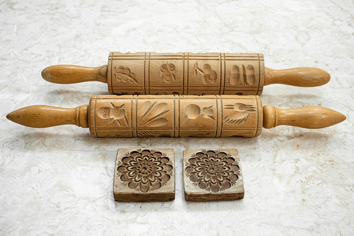 Two springerle rolling pins with impressions and two cookie molds.