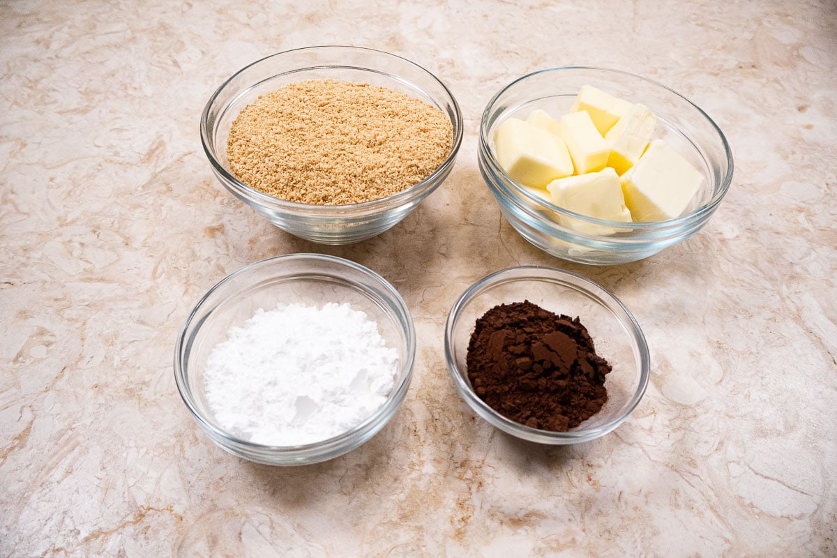 Ingredients for the chocolate crumb crust are graham cracker crumbs, unsalted butter, powdered sugar and cocoa.