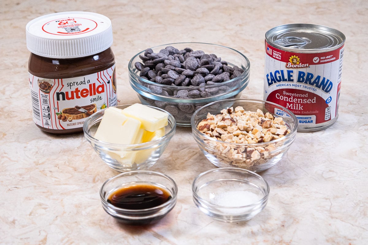 Ingredients for the Nutella Fudge are Nutella, semisweet chocolate, condensed milk, unsalted butter, hazelnuts, vanilla, and sea salt.