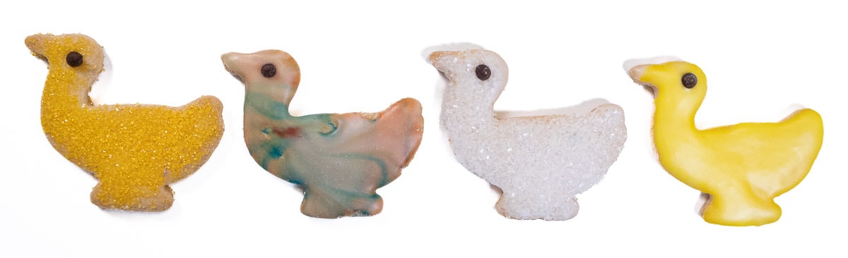 Four ducks finished in a powdered sugar glaze or colored sugar crystals. 