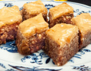 Diamond shaped pieces of Baklava on a blue and white plate.