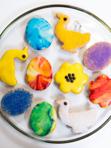 A platter of brightly Decorated Shortbread Cookies for Easter including ducks, flowers and Easter eggs.