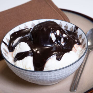 A bowl of vanilla ice cream covered with the Hot Hot Fudge Sundae Sauce.
