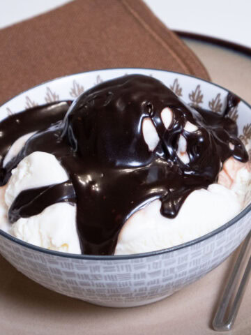A bowl of vanilla ice cream covered with the Hot Hot Fudge Sundae Sauce.