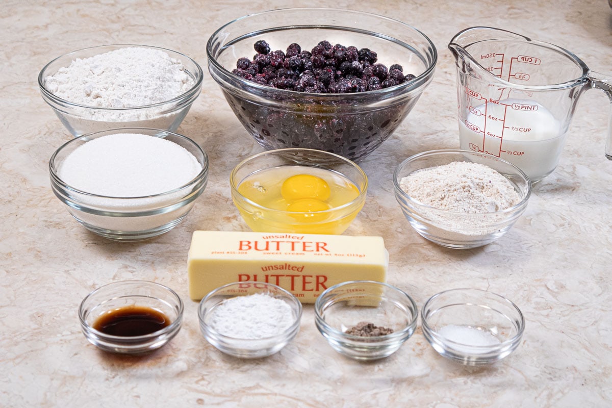 Muffin ingredients include, all-purpose flour, wheat flour, unsalted butter, sugar, eggs, baking powder, salt, vanill, cardamom, milk and blueberries.