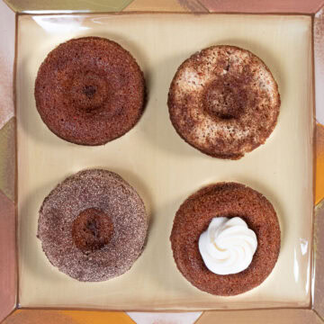 Four finishes on the Carrot Cake Dougnuts are plain, pecan topped, sugared and filled with cream cheese.