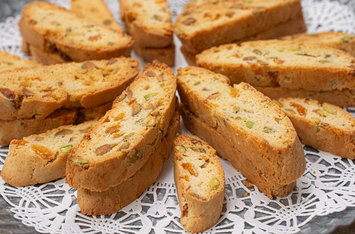 A tray of biscotti, large and mini sit on a doilie.