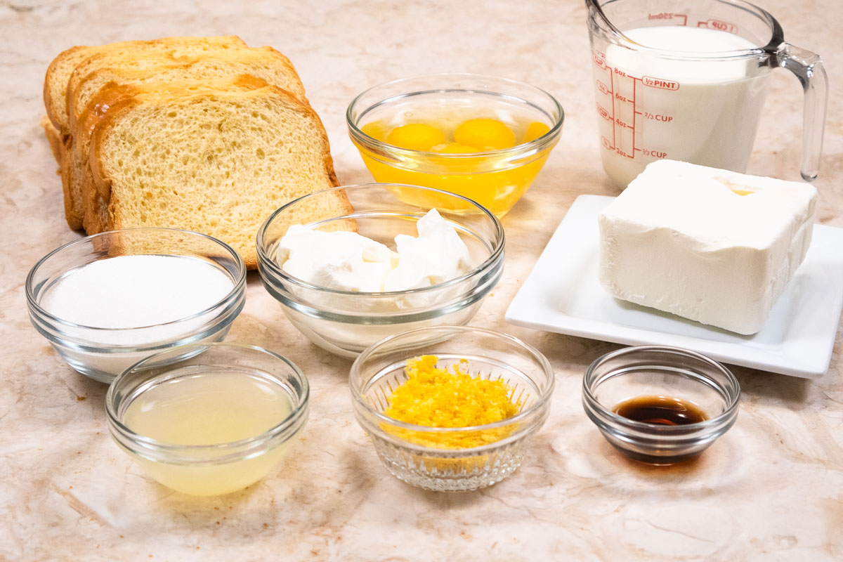 Ingredients for the Lemon Cheesecake Bread Pudding include brioche bread, cream cheese, granulated sugar, citric acid, eggs,lemon zest,vanilla, sour cream, half and half and lemon juice, 