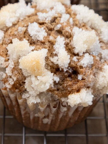 A single Apple Muffin covered with a crunchy sugar topping.