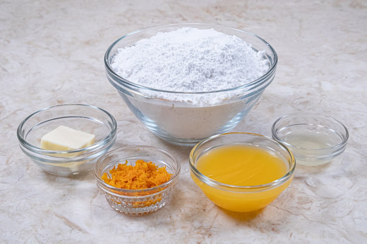 The ingredients for the Orange Glaze are powdered sugar, orange zest, orange  juice, lemon  juice and butter.