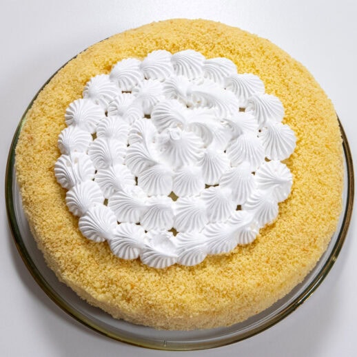 The Triple Lemon Cake consisting of a yellow crumb coated single layer cake finished with white meringue in the middle