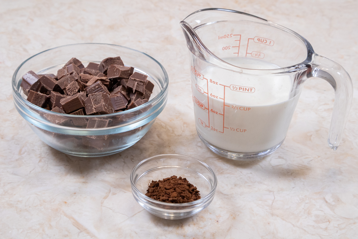 The ingredients for the  milk chocolate layer for the Bailey's Pi Day Pie include instant coffee, milk chocolate, and heavy cream. 