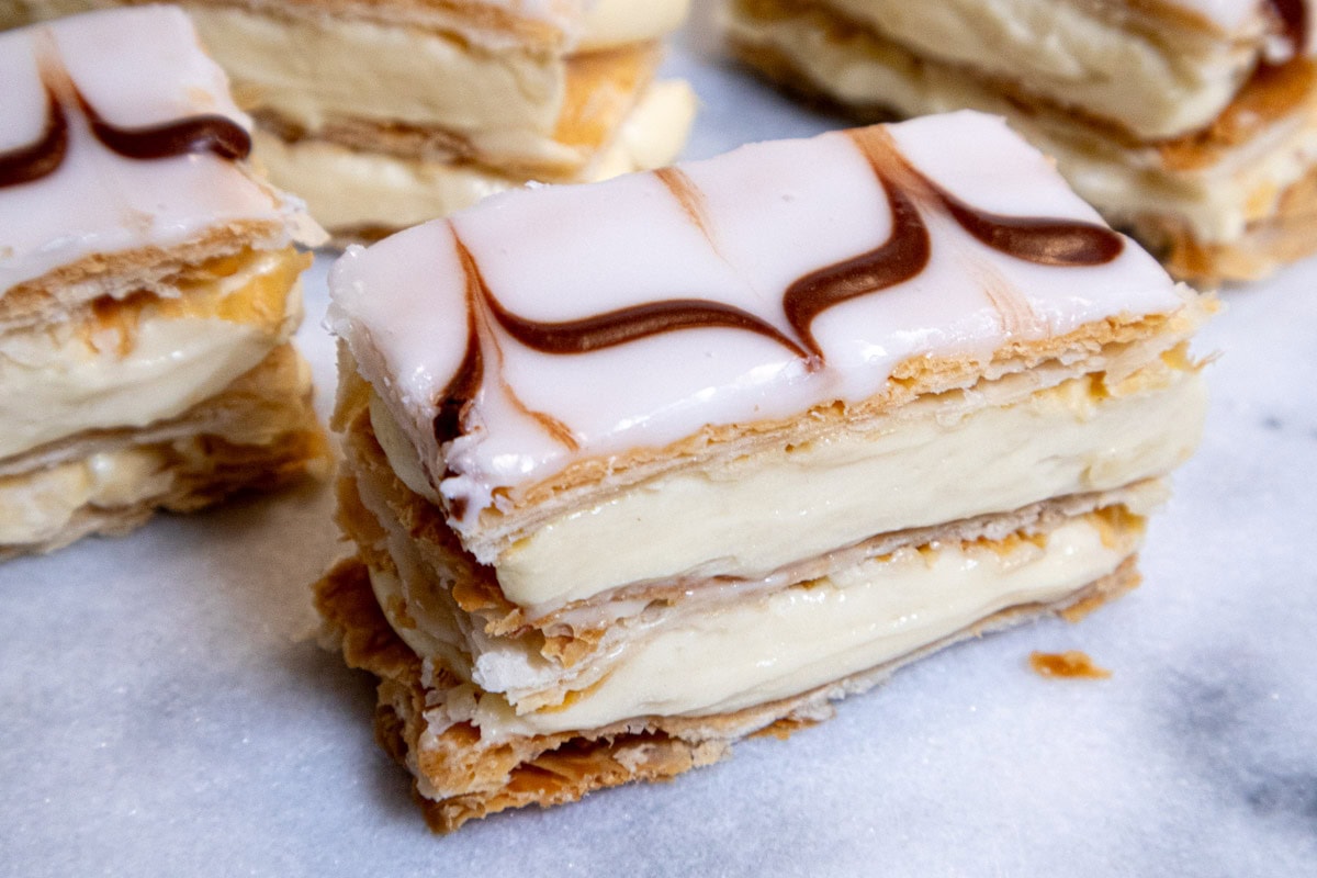 The final photo of the Mille-Feuille shows a slice of the pastry with other slices behind it.