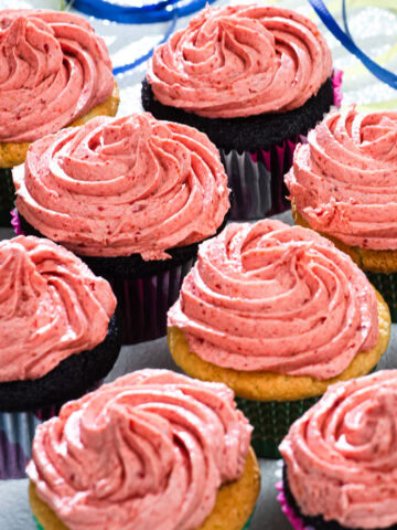 Cupcakes are finished with a swirl of Strawberry Buttercream.