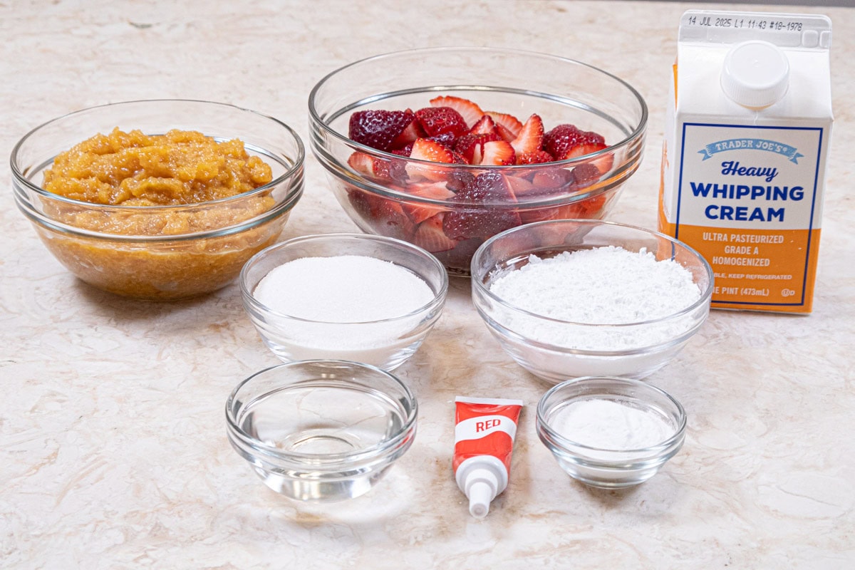 Ingredients to finish the cake are caramelized pineapple, cut strawberries, heavy cream, granulated sugar, powdered sugar, clearjel, water, red food coloring,
