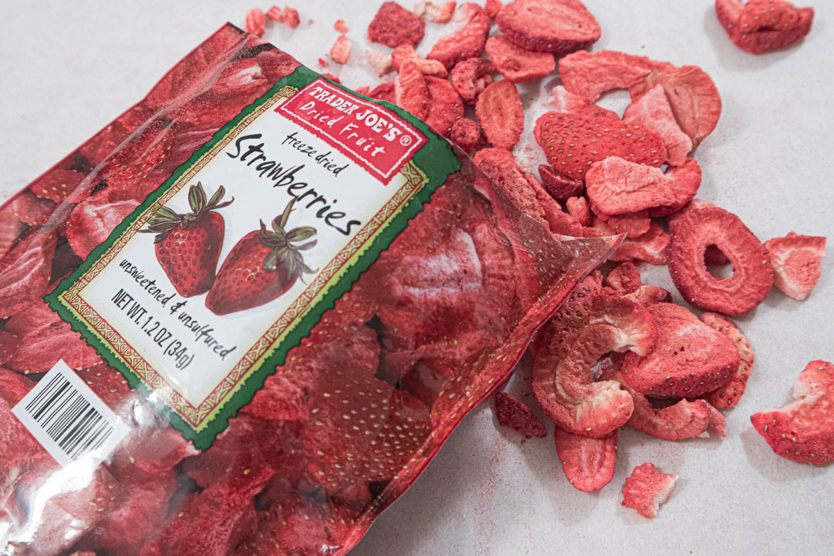 This photo is a package of freeze dried strawberries with the strawberries flowing out.