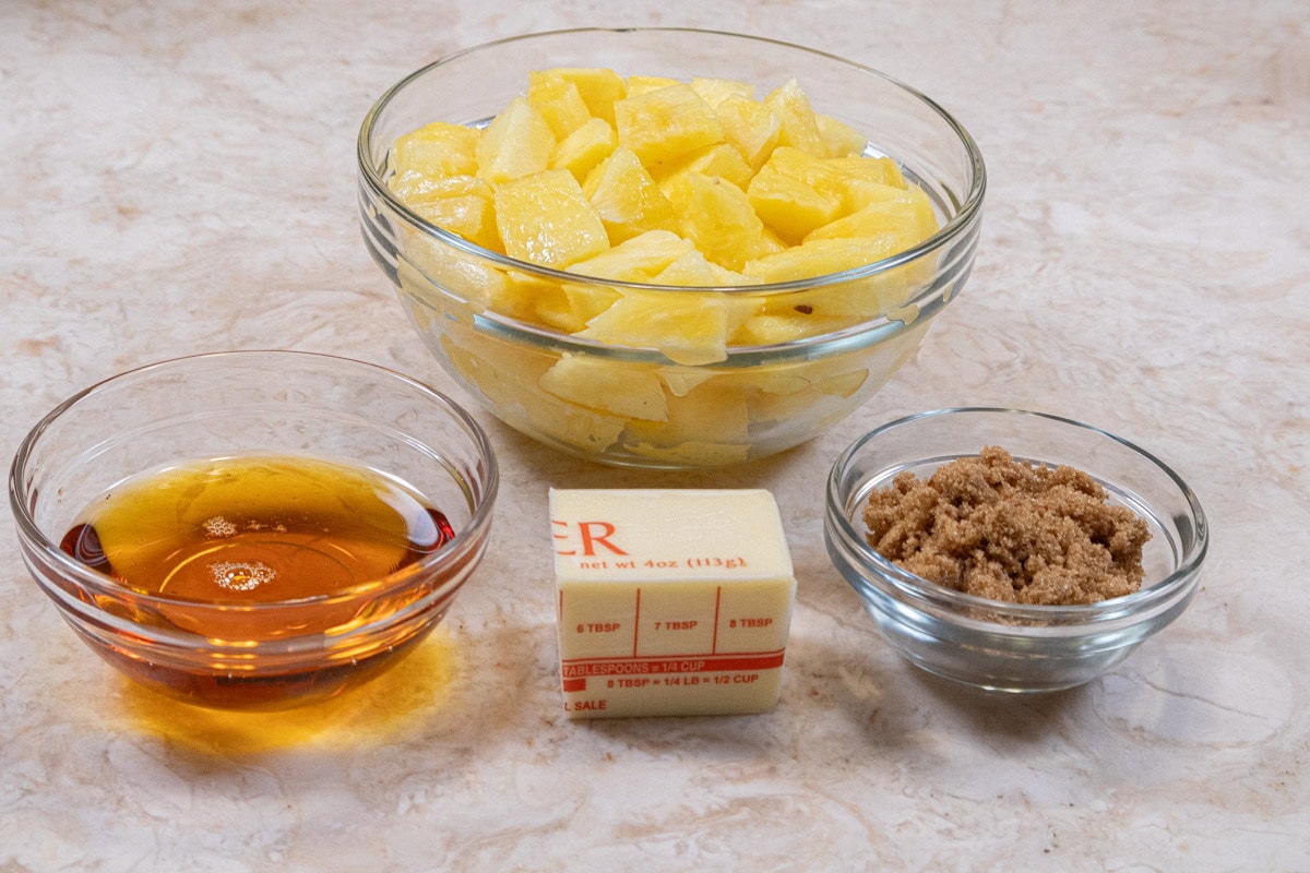The ingredients for the Caramelized Pineapple are golden syrup, unsalted butter, brown sugar and fresh pineapple.