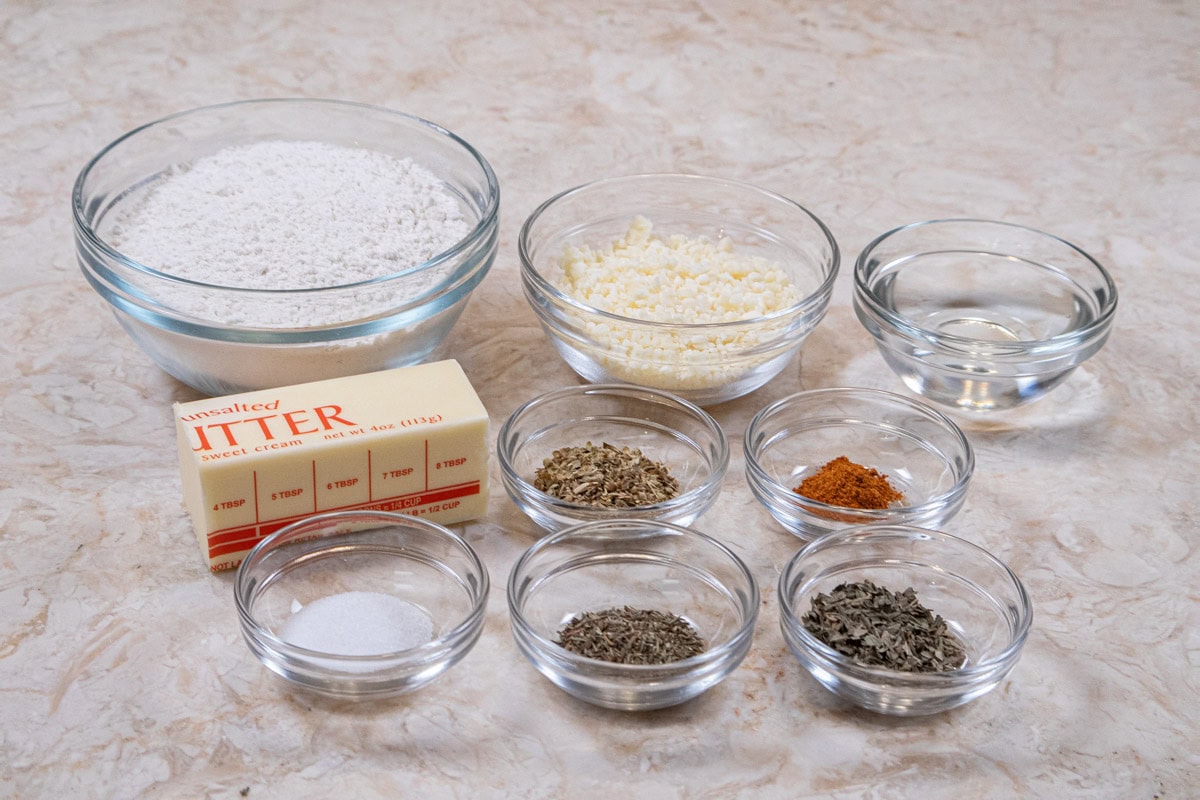 Ingredients for the Summer Vegetable Tart include flour, oregano, basil, thyme, salt, cayenne pepper, parmesan cheese butter and water. 