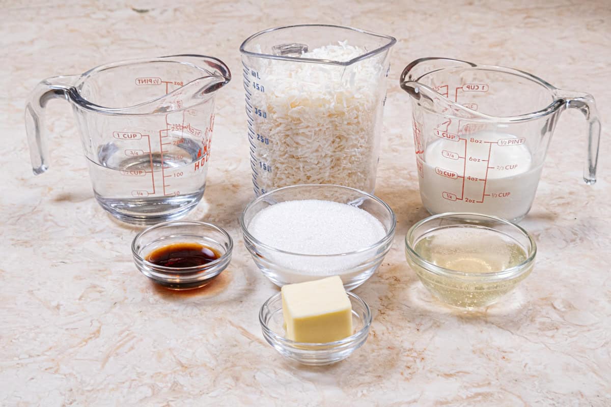 Ingredients for the coconut caramel include, unsalted butter, vanilla extract,granulated sugar, corn syrup, water, desiccated coconut,and  heavy cream. 