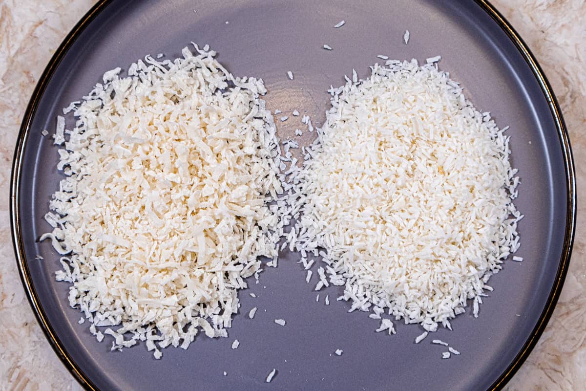 Sweetened coconut and dessicated coconut site on a gray tray.