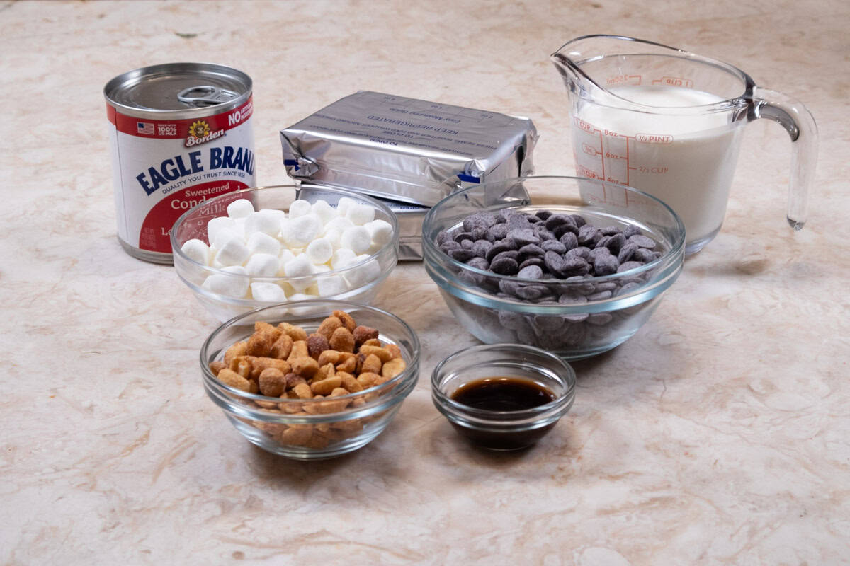 Ingredients for the Rocky Road Cheesecake include : salted, roasted peanuts, semisweet chocoate, heavy cream, cream cheese, condensed milk, vanilla, and  mini-marshmallows.