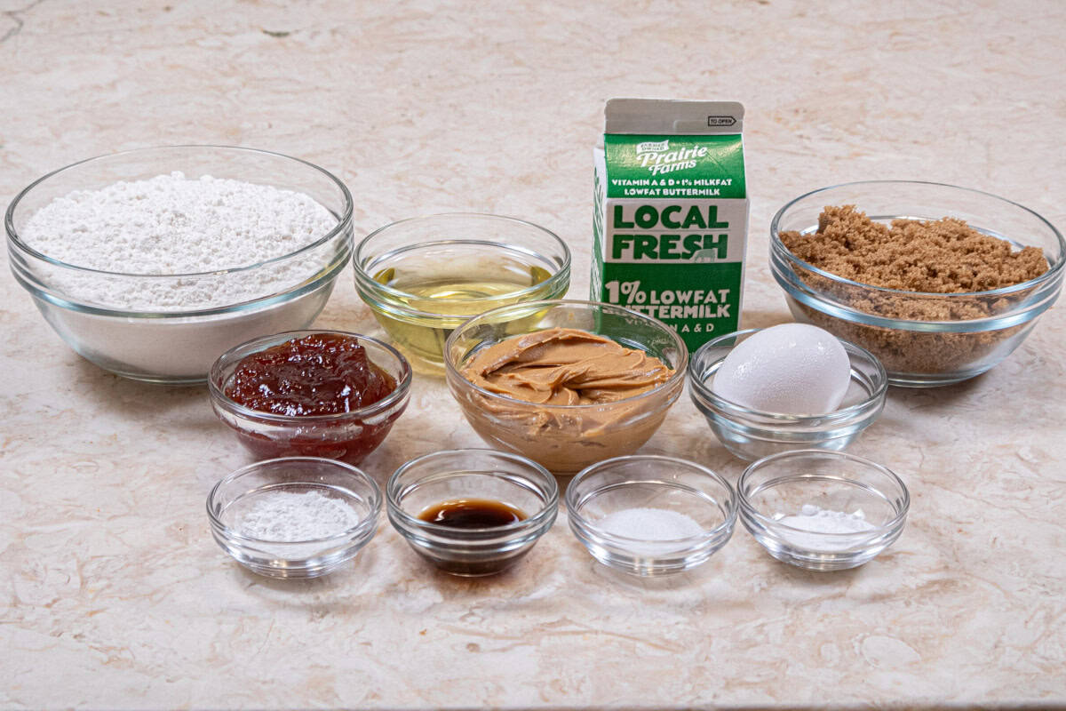 Ingredients for the Peanut Butter & Jam Muffins include all-purpose flour, baking powder, baking soda salt, vegetable oil, brown sugar, egg, vanilla, peanut putter, buttermilk, and jam. 