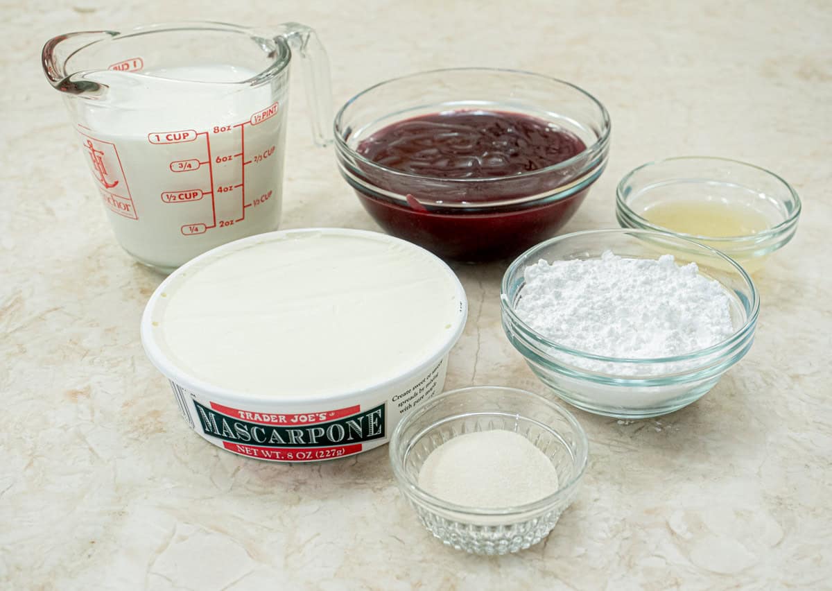 The ingredients for the raspberry mousse include:  seedlesss red raspberry jam, heavy cream, mascarpone, powdered sugar, gelatin and lemon juice.