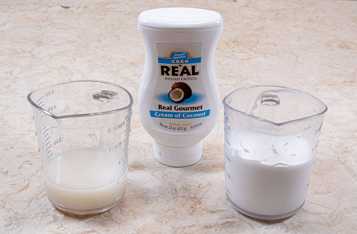 This photo shows the bottle of Coco Reàl Cream of Coconut, coconut cream in a measuring cup and that cream whipped. 