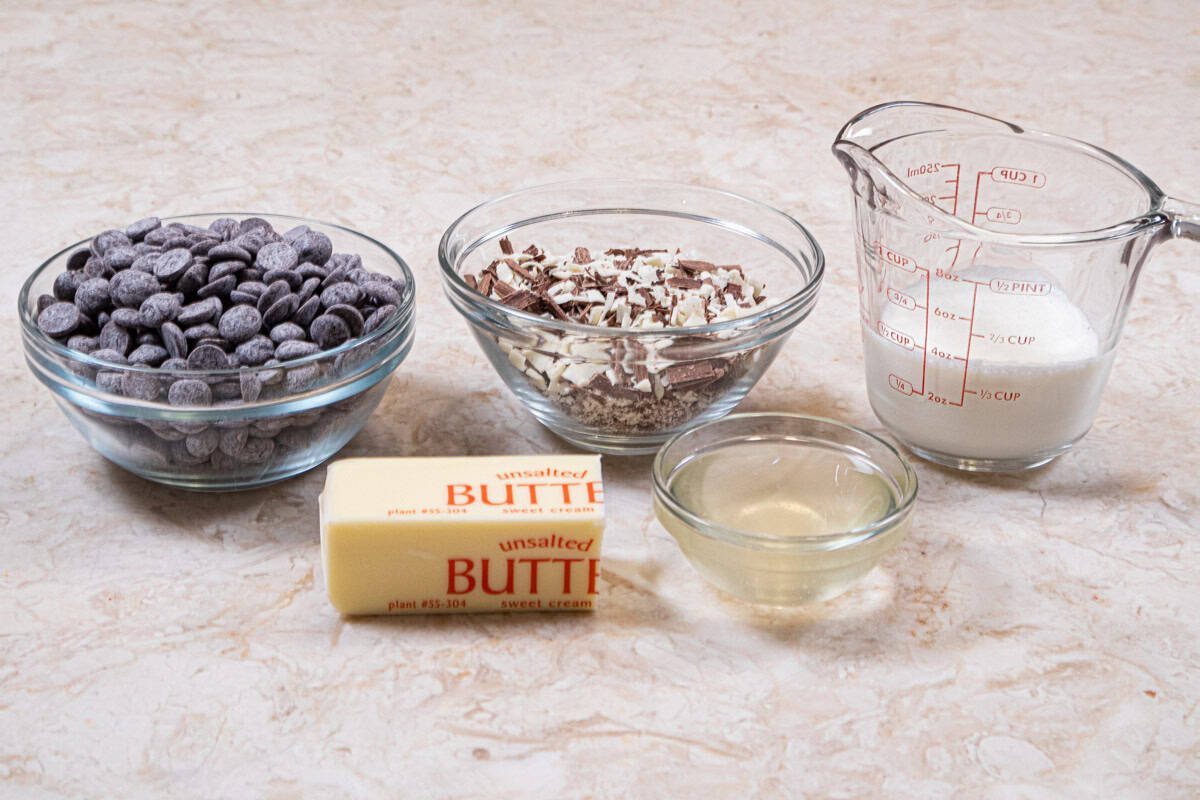 The ingredients to finish the cake are unsalted butter, corn syrup, semi sweet chocolate, heavy cream and multi-colored chocolate curls. 