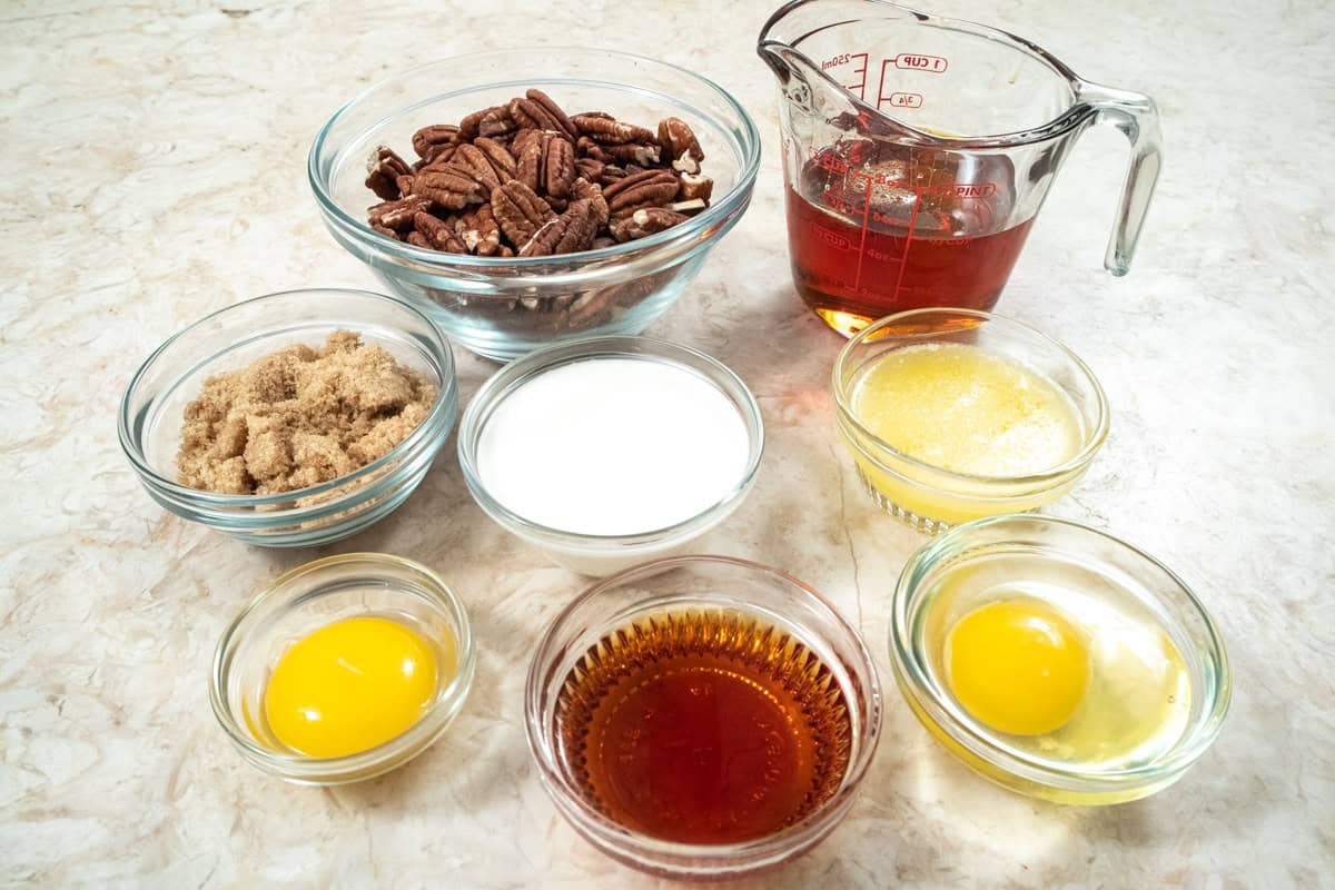 Ingredients for the filling are toasted pecans, golden syrup, brown sugar, egg, egg yolk, heavy cream, dark drum, unsalted butter, and salt. 