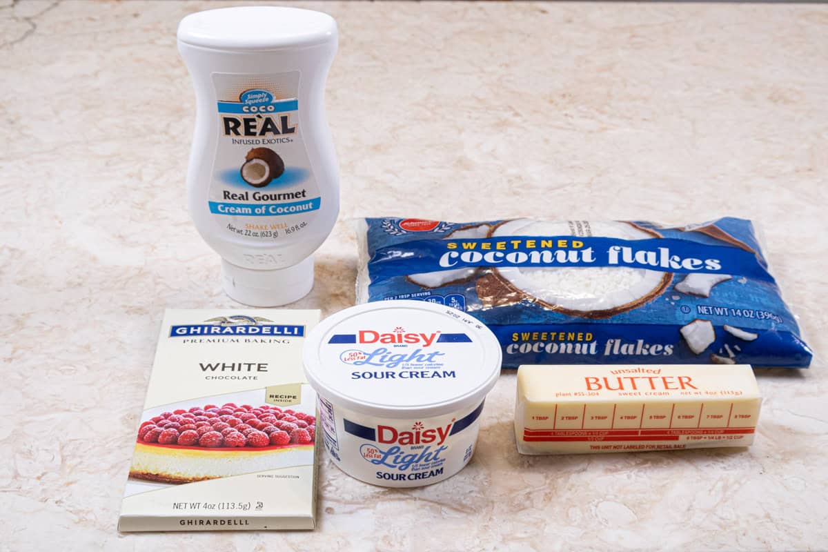 Ingredients for the coconut filling are:  cream of coconut, sweetened coconut, white chocolate, sour cream and unsalted butter.