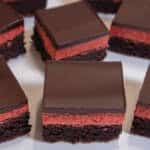 Multiple Strawberry Brownies sit on a white background.