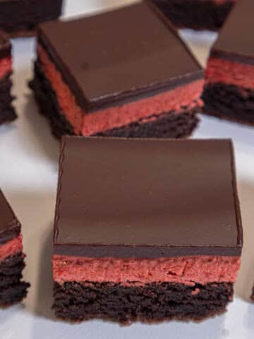 Multiple Strawberry Brownies sit on a white background.