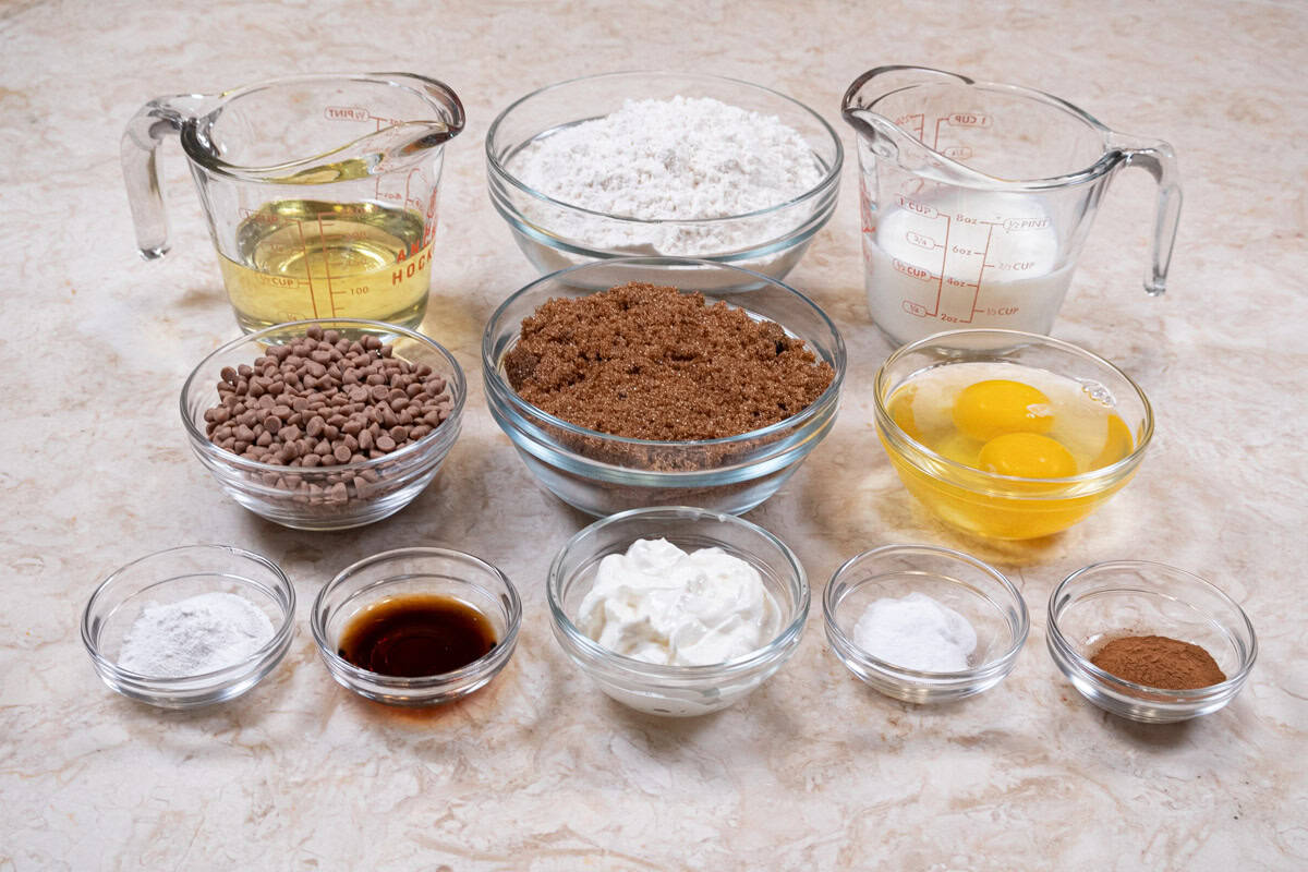 Ingredients for the Coffee Cake Muffins are brown sugar, canola oil, eggs, buttermilk, sour cream vanilla all-purpose flour, cinnamon, baking powder, baking soda and cinnamon chips.