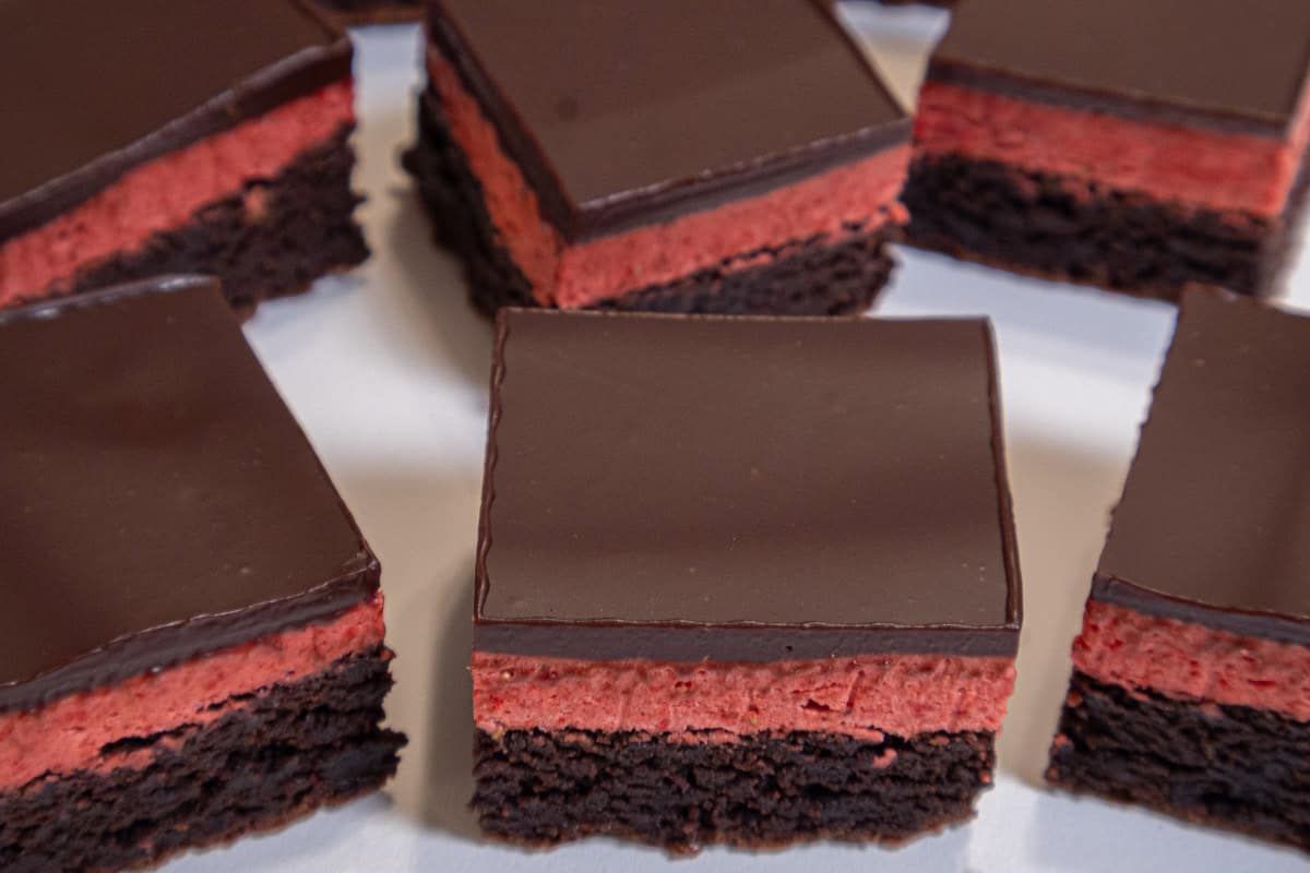 Multiple Strawberry Brownies sit on a white background.