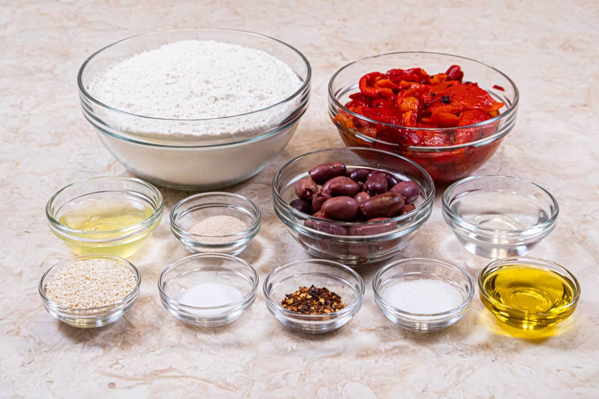 Ingredients for the Sweet & Hot Red Pepper & Olive Bread include: roasted red peppers, water, yeast, oil, red pepper flakes, bread flour, salt olives, egg white and sesame seeds.