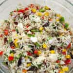 A close up photo of the Mediterranean Orzo Salad shows the cut up veggies, olives and cheese surrounding the orzo pasta.