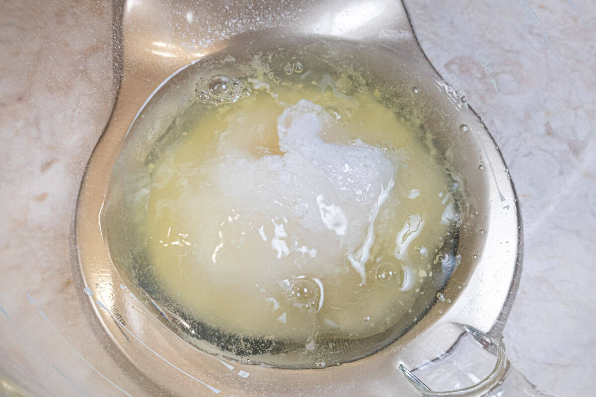 The egg whites, sugar and cream of tartar are added to the mixing bowl. 