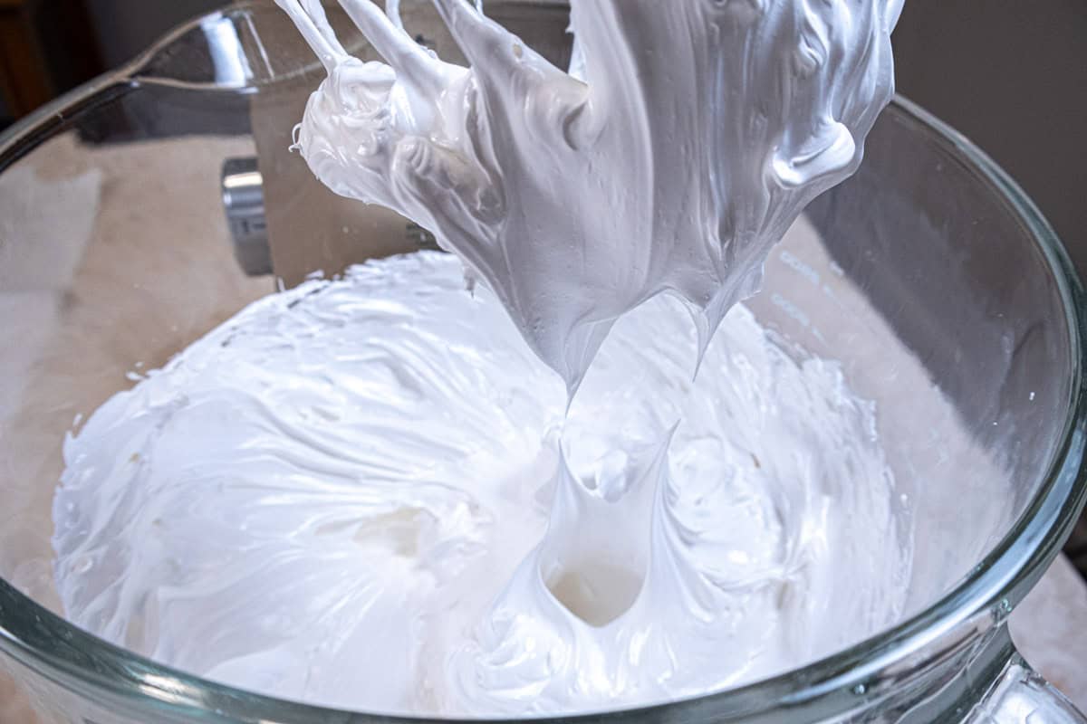 The meringue makes stiff peaks when the whisk is removed. 